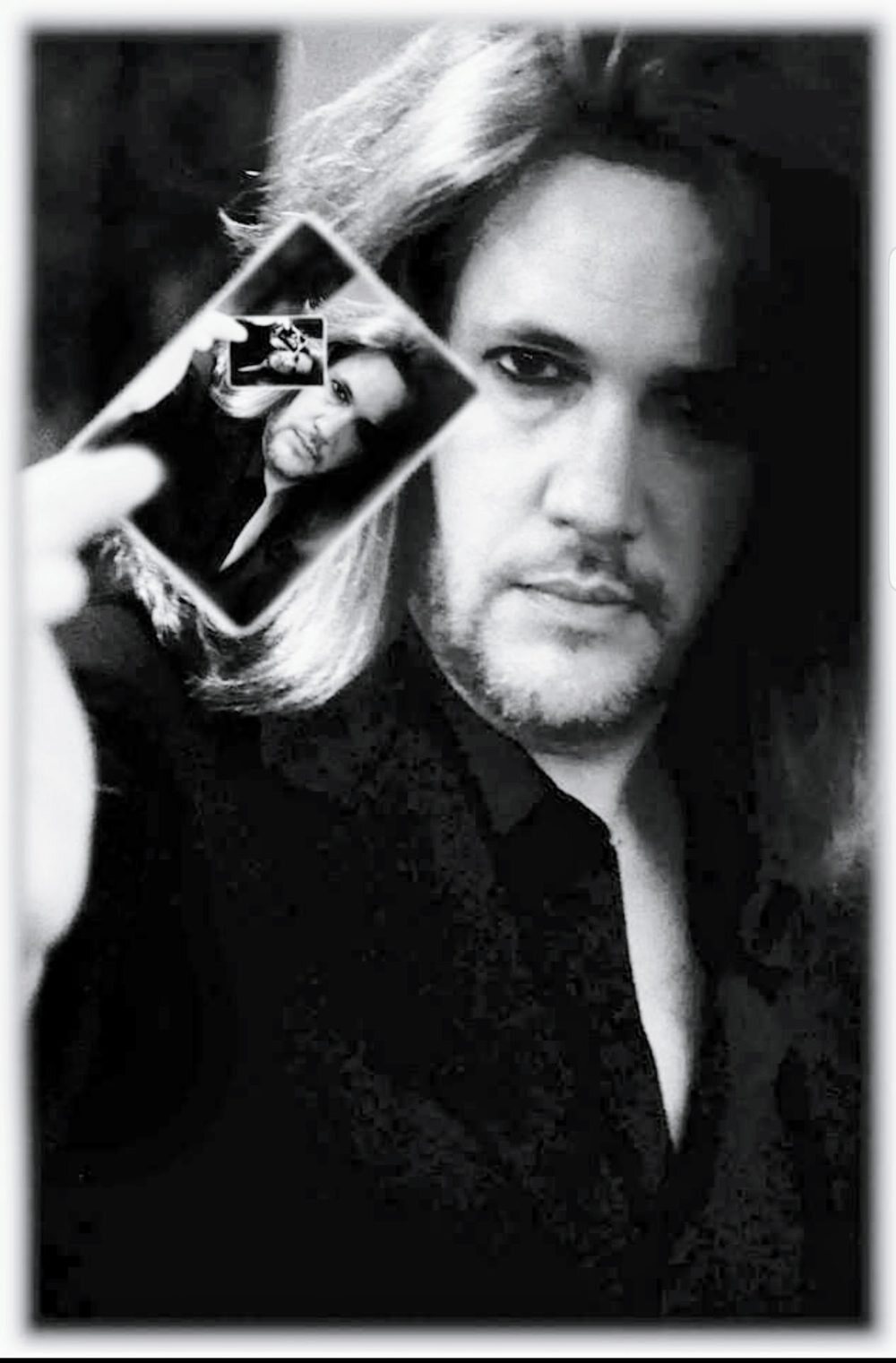 V, close-up magician and mentalist, holding a playing card